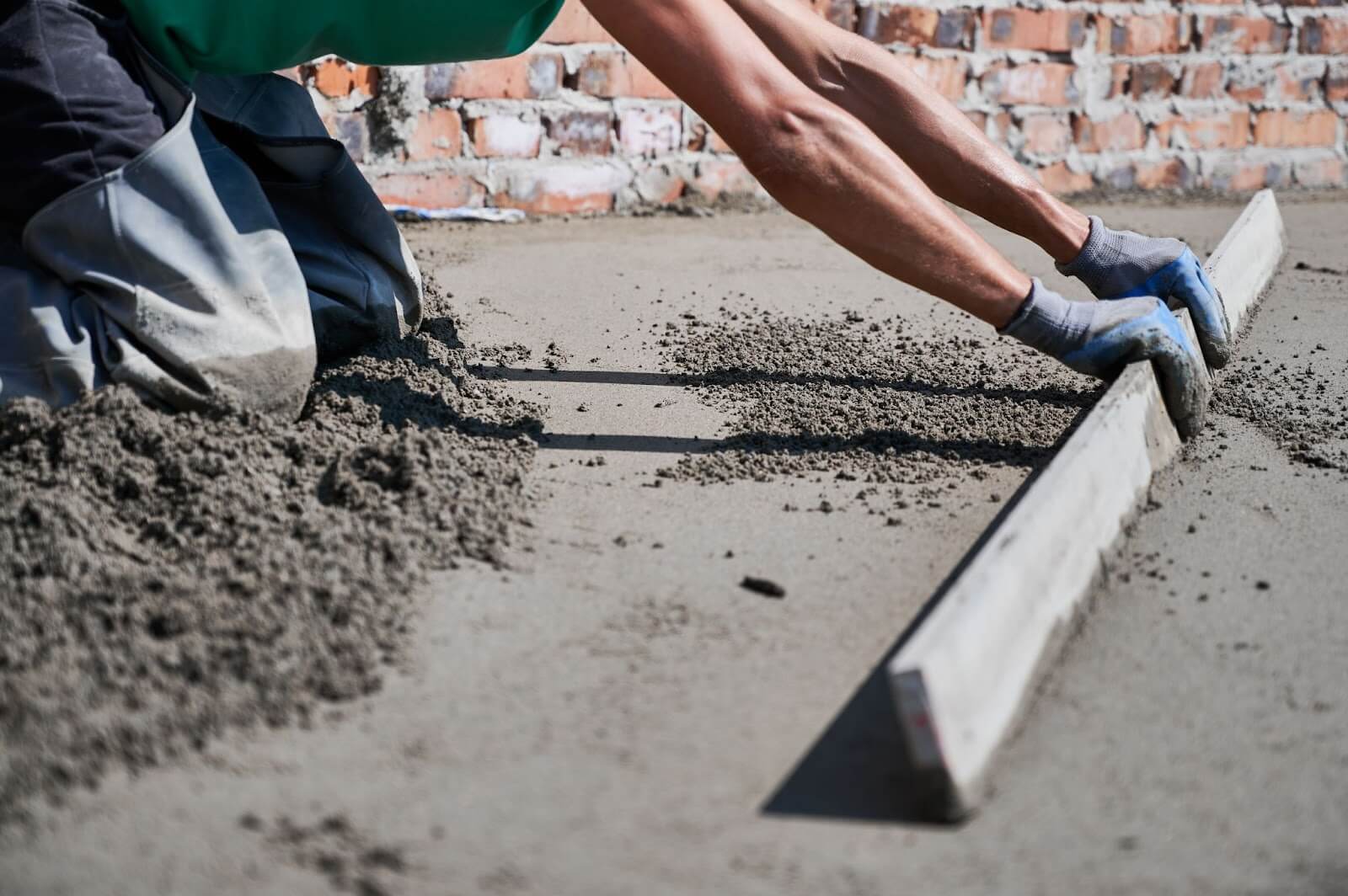 Worker installing commercial concrete flooring