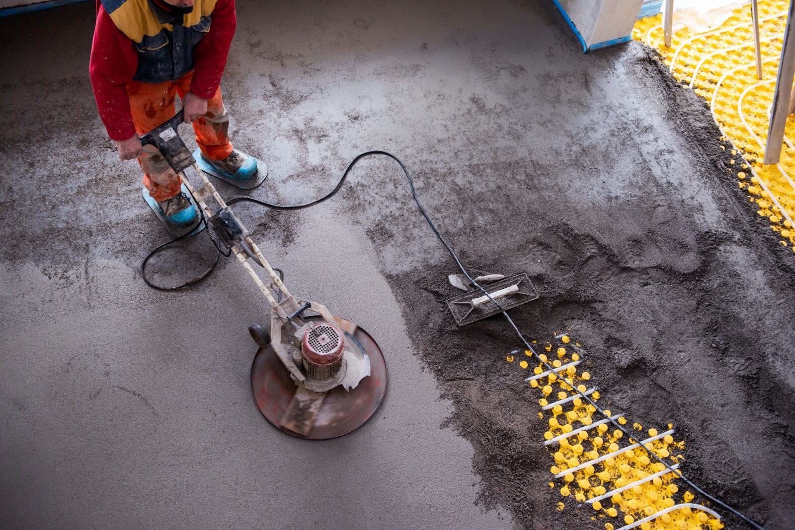 Worker cleaning commercial concrete flooring